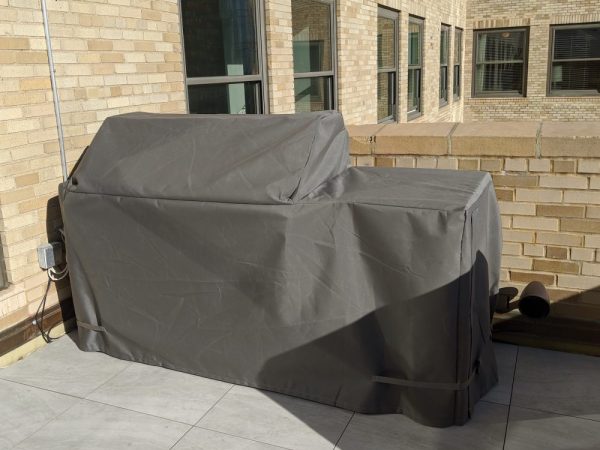 8224-Electric Grill Island Outdoor grill on porch with brown fabric cover