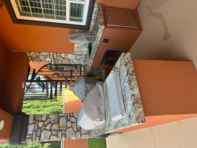 Outdoor kitchen with granite countertops, and custom covered grills