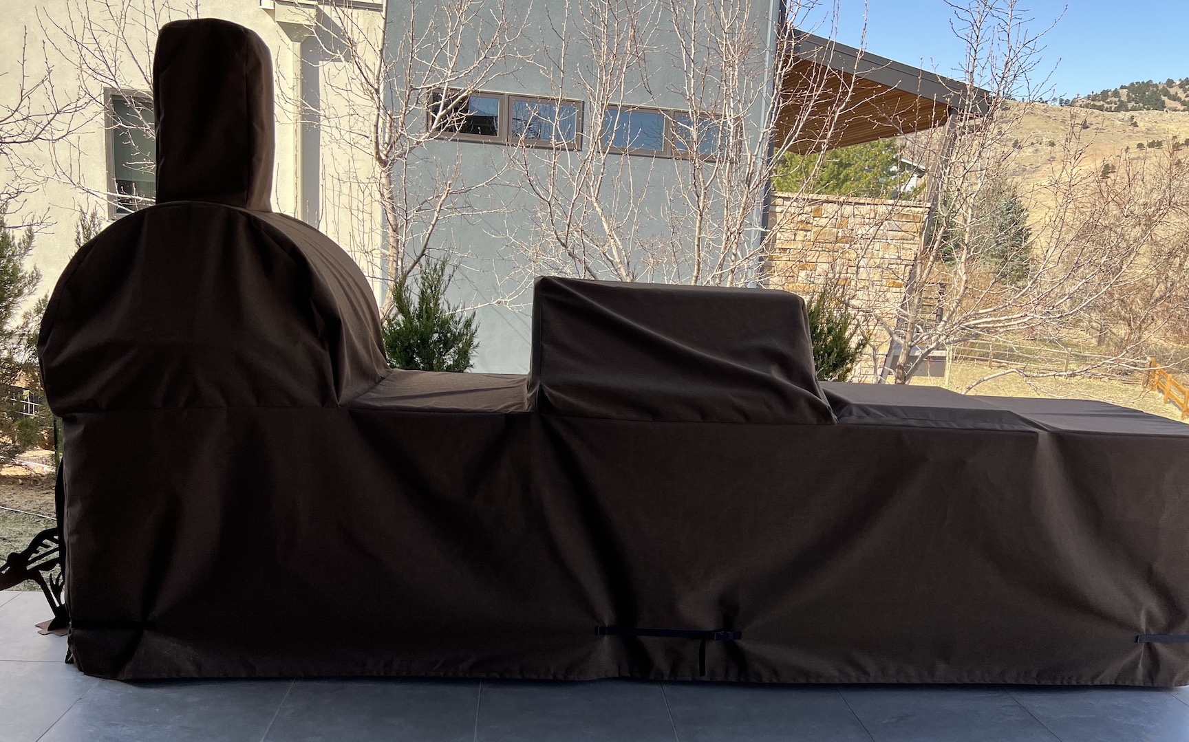 Outdoor grill and smoker combo with black fabric cover