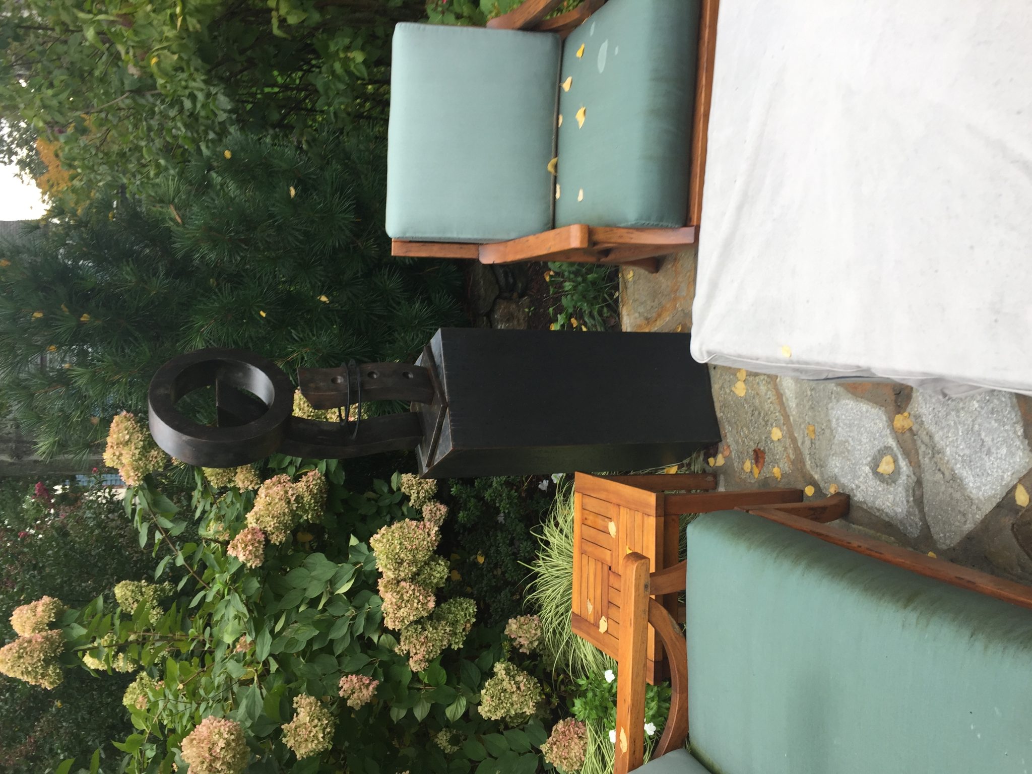 Black sculpture in backyard garden